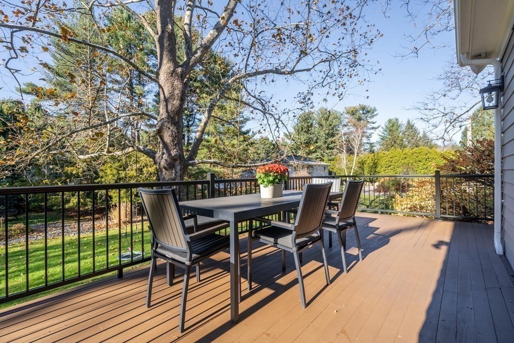 4 Pond Brook Circle Weston, MA 02493 - Photo 27 of 35 a view of a roof deck with table and chairs and wooden floor
