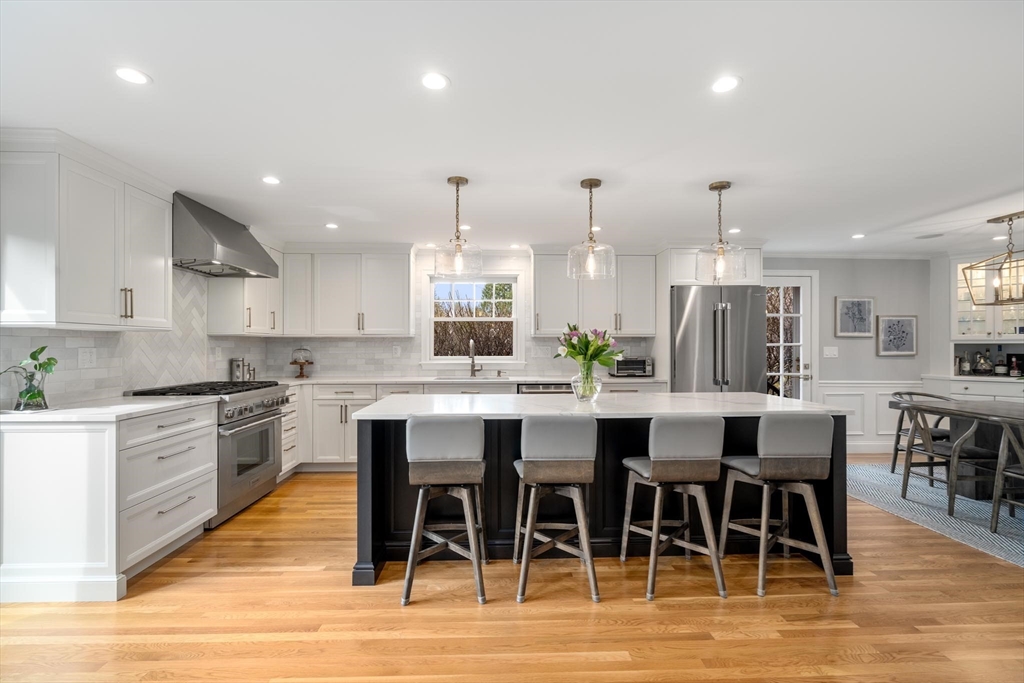 4 Pond Brook Circle Weston, MA 02493 - Photo 6 of 35 a large kitchen with a table and chairs