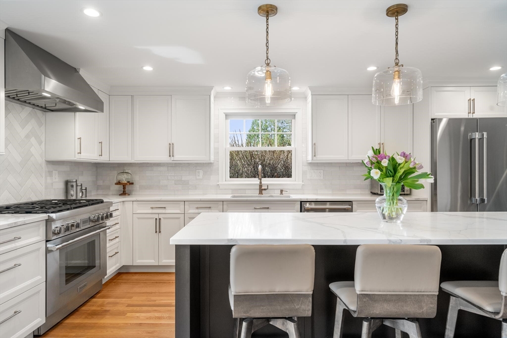 4 Pond Brook Circle Weston, MA 02493 - Photo 7 of 35 a kitchen with a table and chairs in it