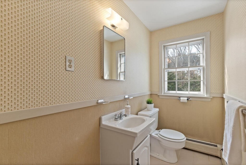 73 Thornberry Road Winchester, MA 01890 - Photo 20 of 39 a bathroom with a sink a toilet and window