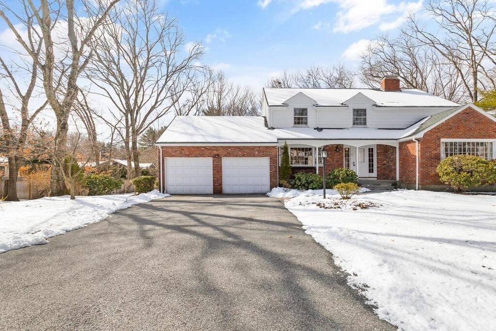 73 Thornberry Road Winchester, MA 01890 - Photo 2 of 39 a front view of a house with a yard and garage