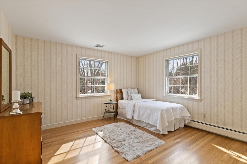 73 Thornberry Road Winchester, MA 01890 - Photo 28 of 39 a bedroom with a large bed a rug and a window