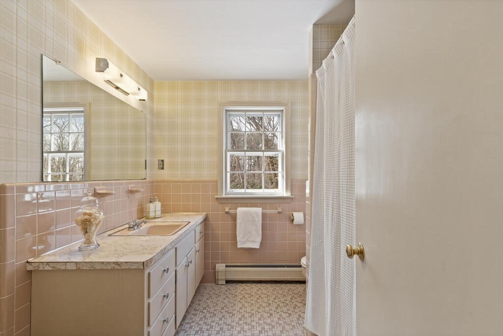 73 Thornberry Road Winchester, MA 01890 - Photo 29 of 39 a bathroom with a granite countertop sink mirror and a bathtub