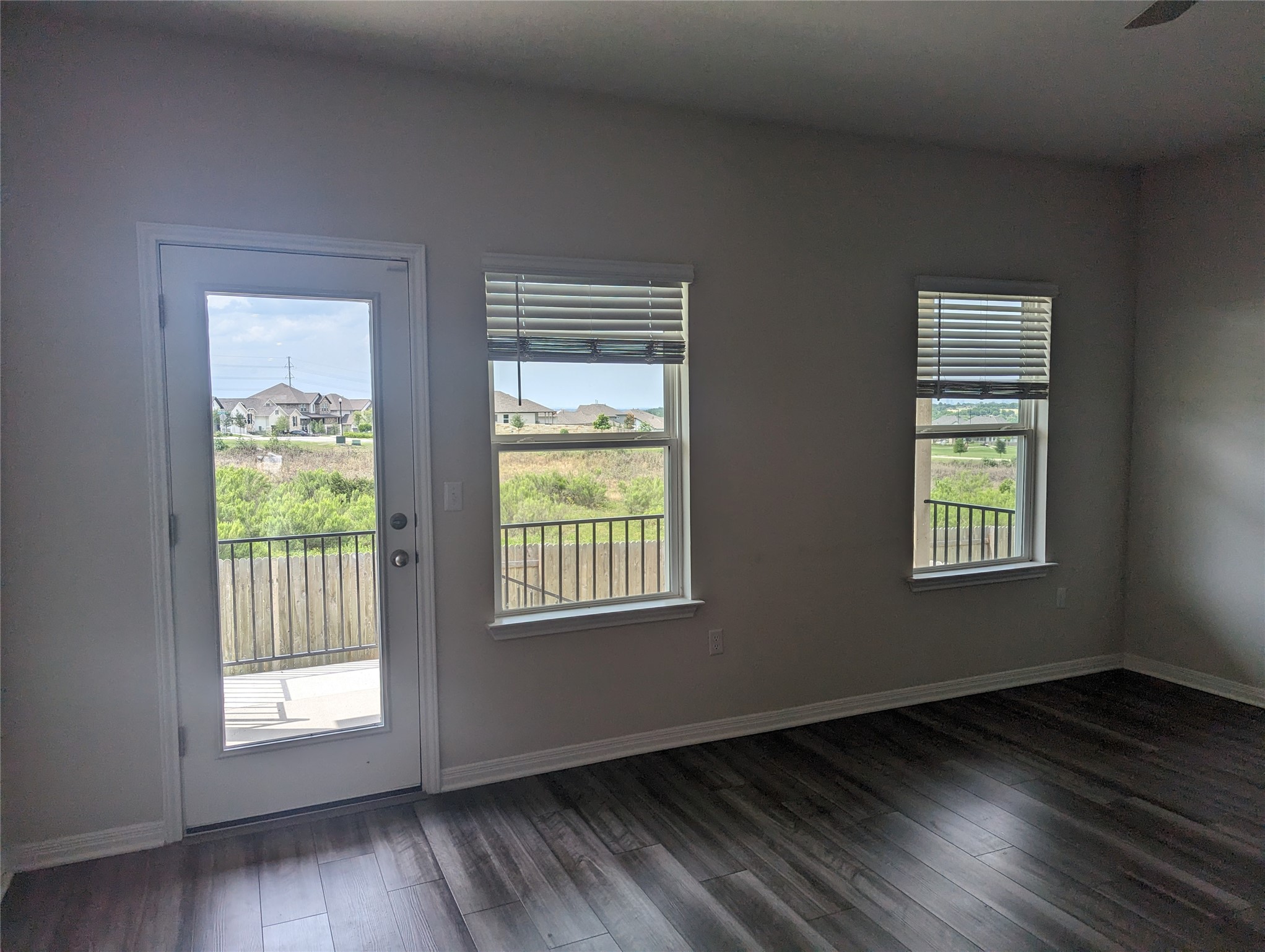 6400 Rounded Pebble Lane Buda, TX 78610 - Photo 22 of 34 a view of an empty room with wooden floor and a window