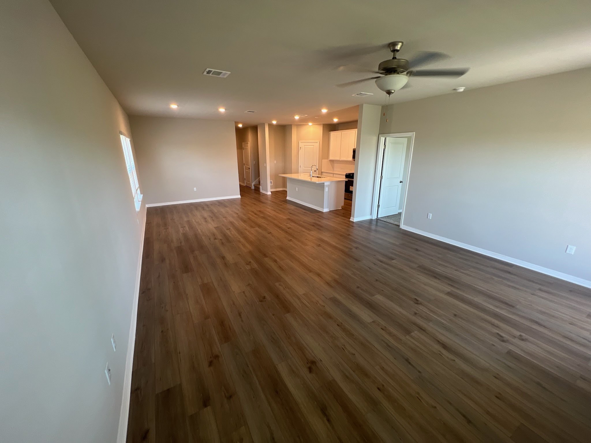 6400 Rounded Pebble Lane Buda, TX 78610 - Photo 6 of 34 a view of a big room with wooden floor and windows