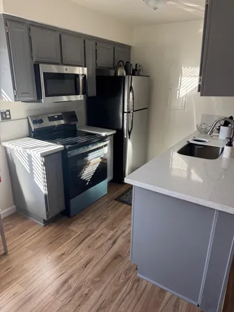 a kitchen with stainless steel appliances a stove a microwave and a refrigerator