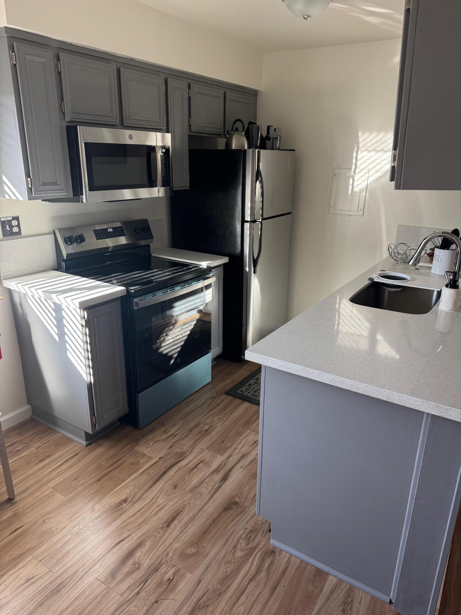 72670 Thrush Road, Unit 4 Palm Desert, CA 92260 - Photo 3 of 7 a kitchen with stainless steel appliances a stove a microwave and a refrigerator