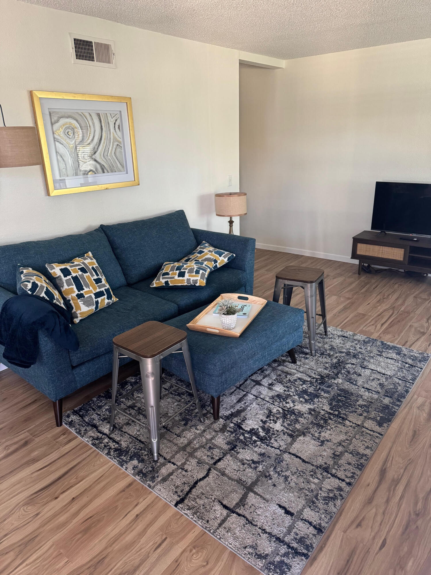 72670 Thrush Road, Unit 4 Palm Desert, CA 92260 - Photo 4 of 7 a living room with furniture and a wooden floor