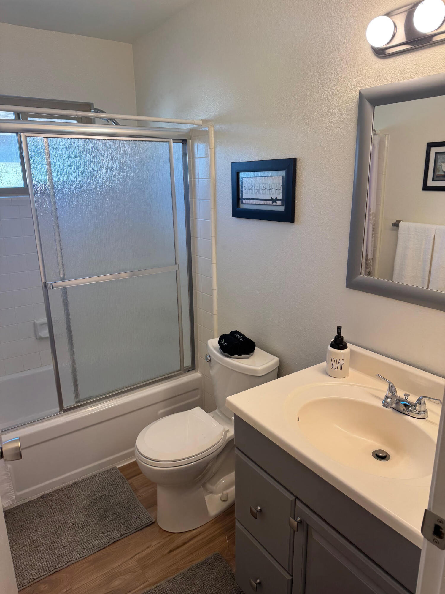 72670 Thrush Road, Unit 4 Palm Desert, CA 92260 - Photo 5 of 7 a bathroom with a sink a toilet a mirror and shower