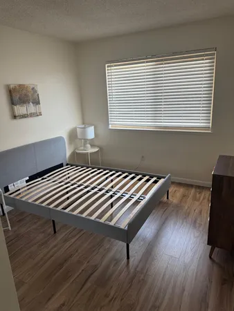 a bedroom with bed and a window