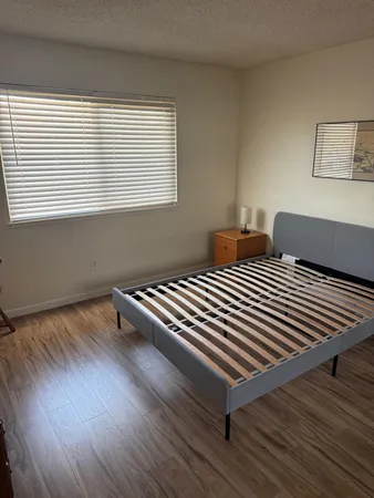 a bedroom with two beds and a window