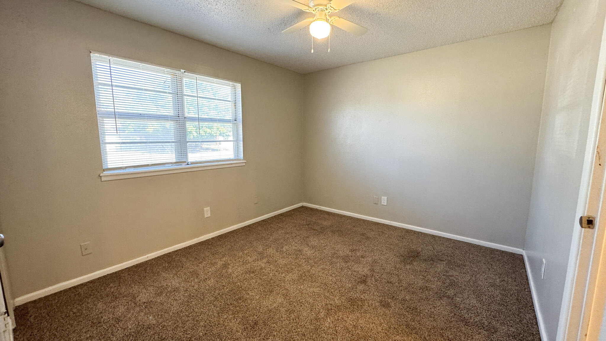 4825 53rd Street Lubbock, TX 79414 - Photo 11 of 13 an empty room with a window