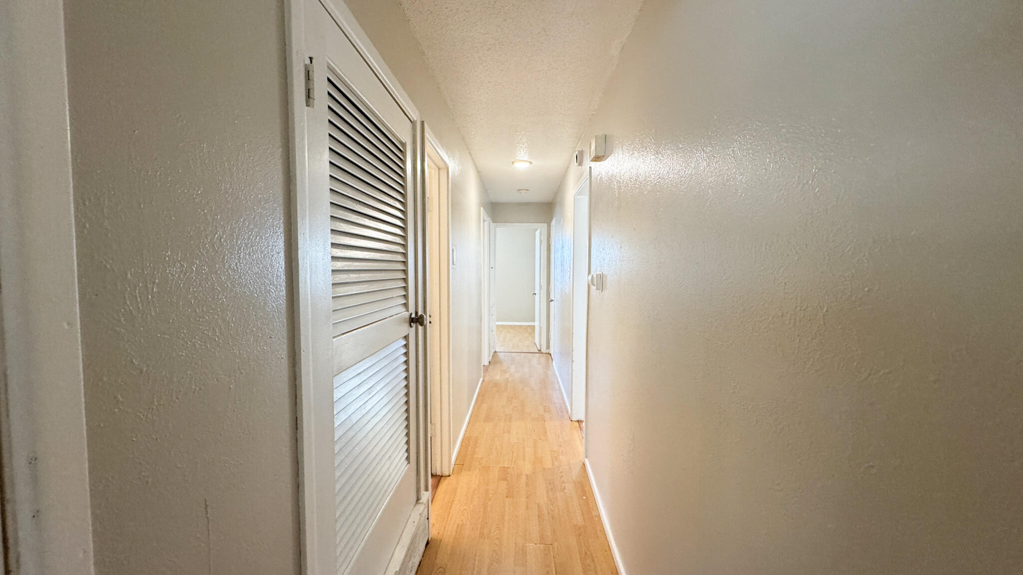 4825 53rd Street Lubbock, TX 79414 - Photo 9 of 13 a view of a hallway with wooden floor
