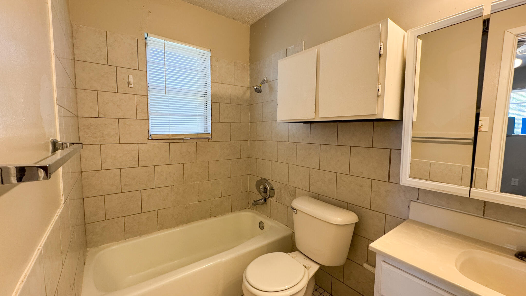 4825 53rd Street Lubbock, TX 79414 - Photo 10 of 13 a bathroom with a sink toilet and shower