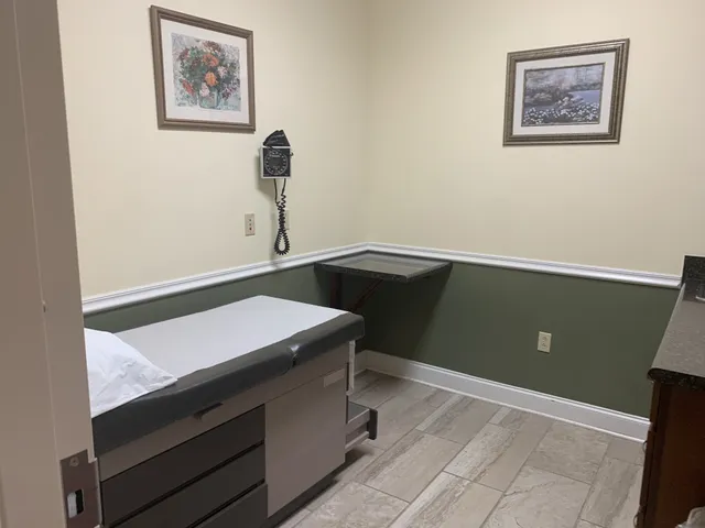 a room with a desk and painting on the wall