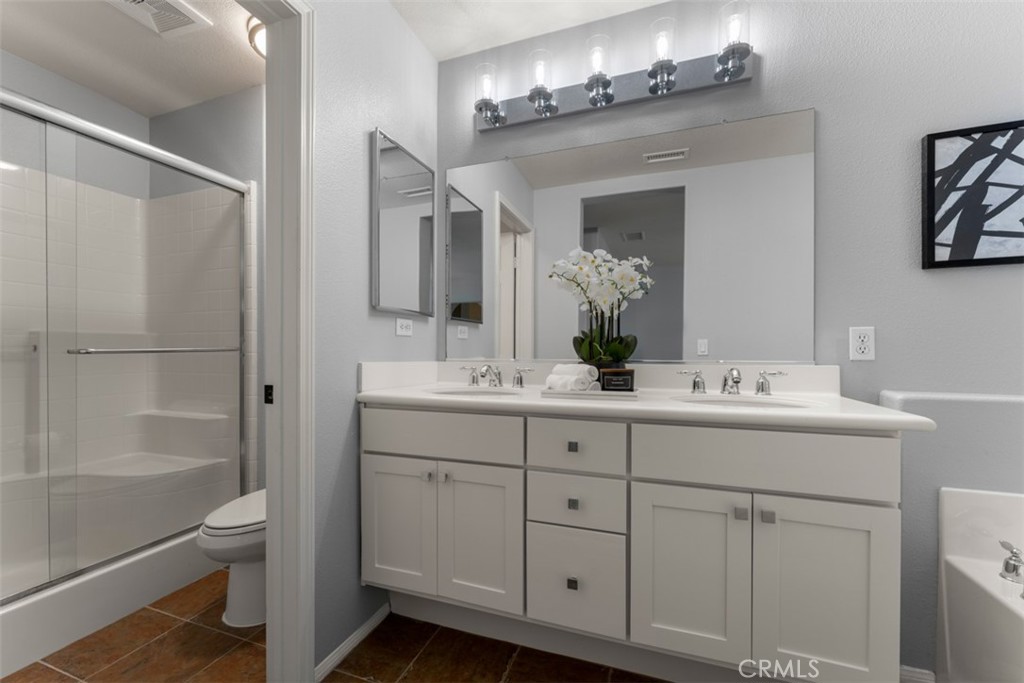 46 Platinum Circle Ladera Ranch, CA 92694 - Photo 25 of 37 a bathroom with a toilet a sink a mirror and a shower