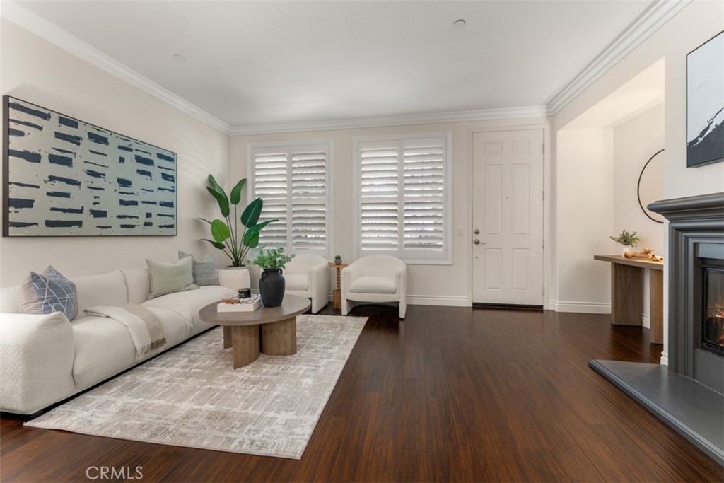 46 Platinum Circle Ladera Ranch, CA 92694 - Photo 6 of 37 a living room with furniture wooden floor and a fireplace