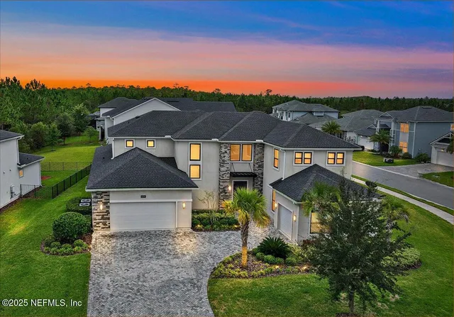 an aerial view of a house with a yard basket ball court and a fountain