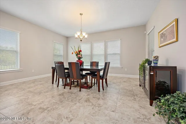 a view of a dining room with furniture and chandelier