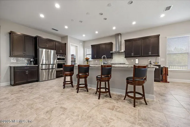 a kitchen with stainless steel appliances a refrigerator and a microwave