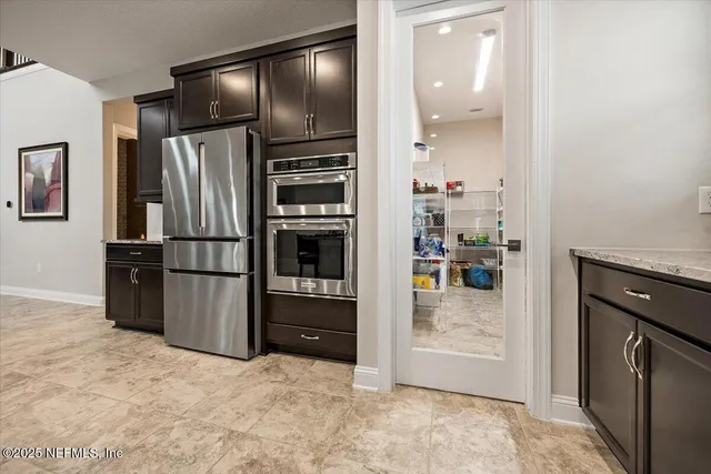 a kitchen with granite countertop a refrigerator and a stove