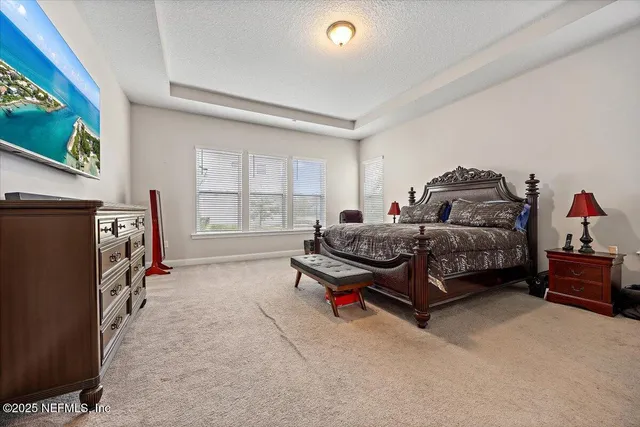 a living room with furniture a flat screen tv and a window
