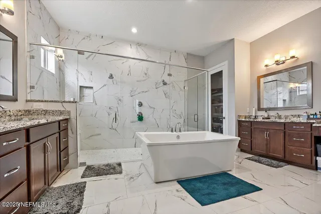 a spacious bathroom with a tub sink and mirror