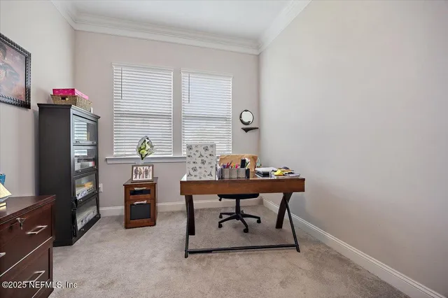 a view of a workspace with furniture and a window