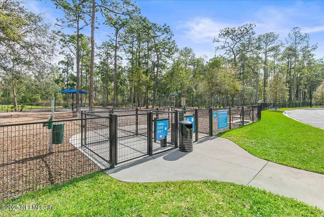 a view of a park with iron fence