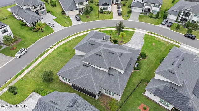 an aerial view of a house with a swimming pool