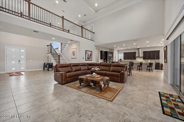 a living room with furniture kitchen view and a table