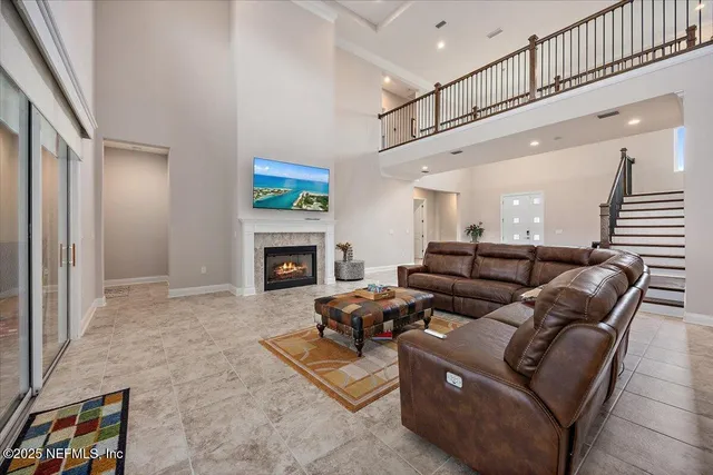 a living room with furniture a fireplace and a flat screen tv