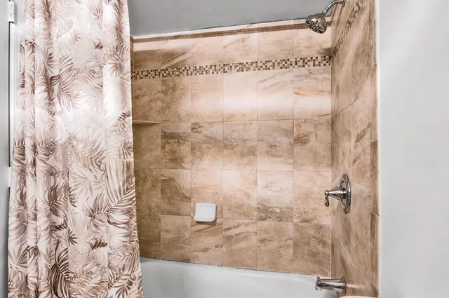 a bathroom with a glass shower door