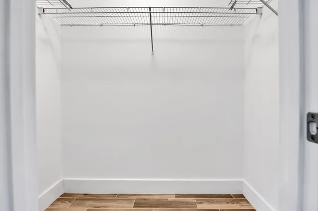 a view of a room with wooden floor