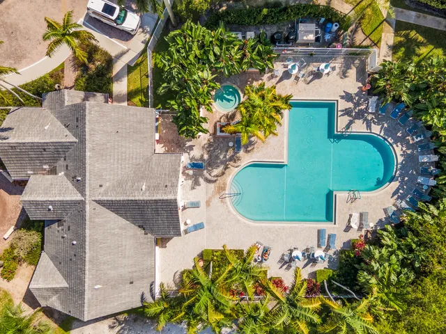 an aerial view of a house with a swimming pool
