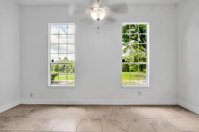 an empty room with windows and closet