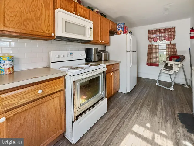 a kitchen with stainless steel appliances granite countertop a stove a refrigerator and a cabinets