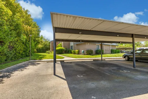 a view of a house with backyard porch and sitting area