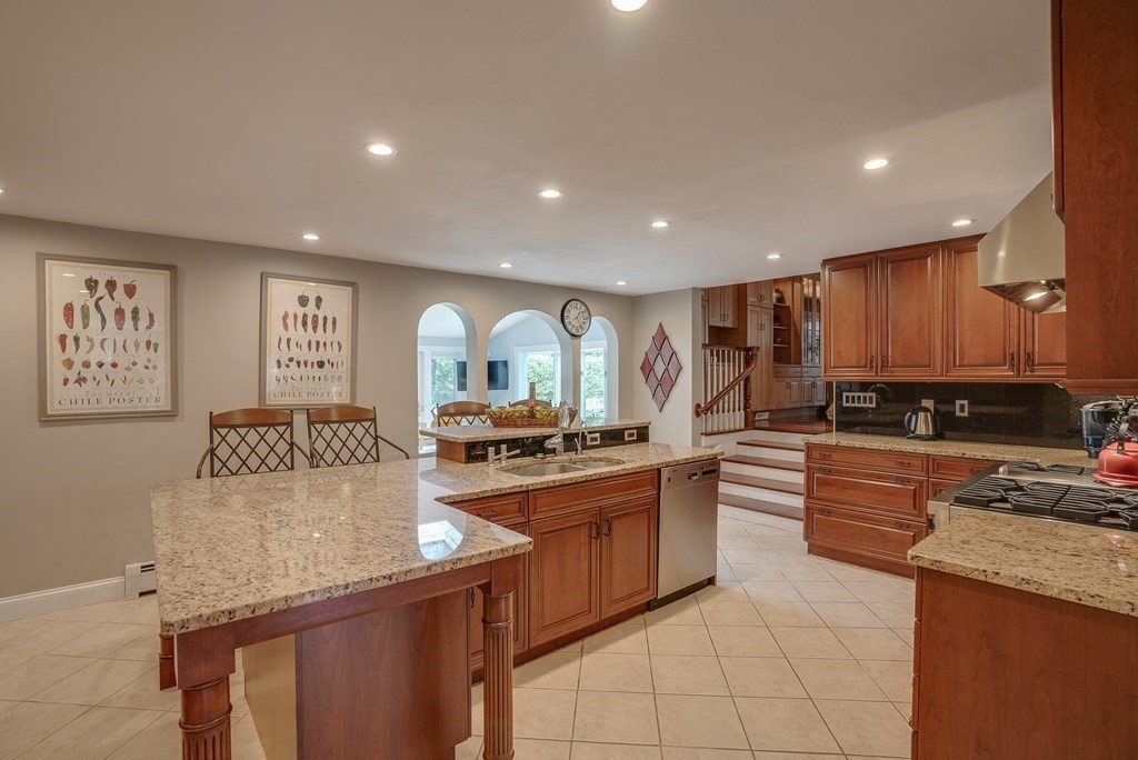 6 Braeburn Road Chelmsford, MA 01824 - Photo 5 of 42 a kitchen with stainless steel appliances granite countertop a stove top oven a sink a counter top space and cabinets