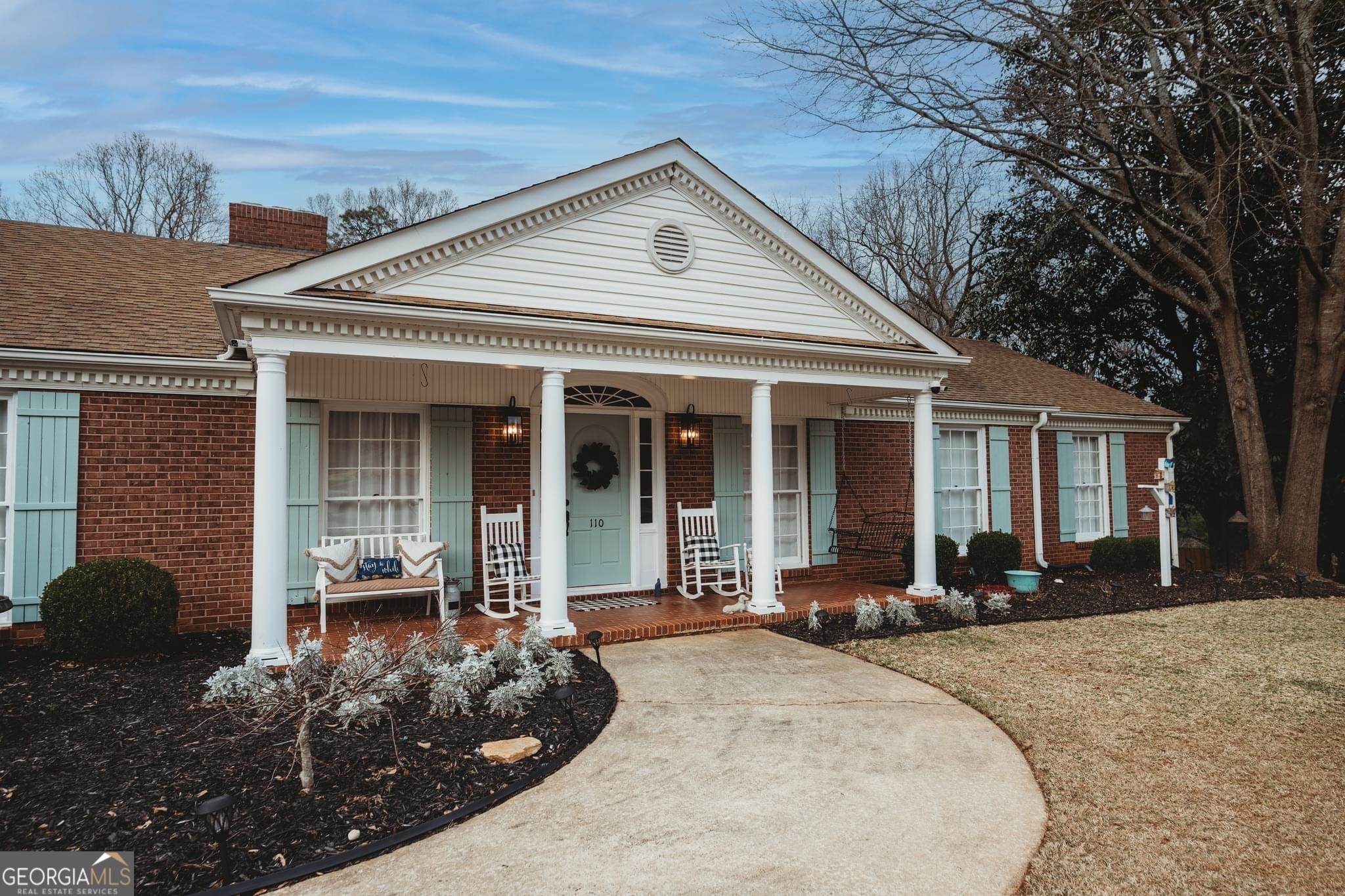 a front view of a house with a sitting area