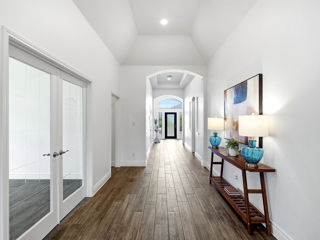 109 Lake Spring Circle Georgetown, TX 78633 - Photo 5 of 38 An inviting entry hallway features warm tile wood-look flooring and an elegant arched doorway.