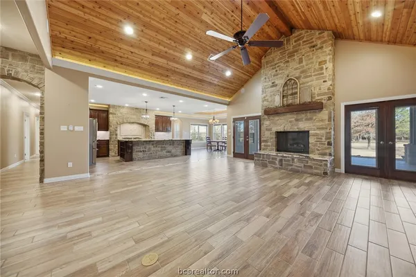 a view of empty room with wooden floor and fireplace