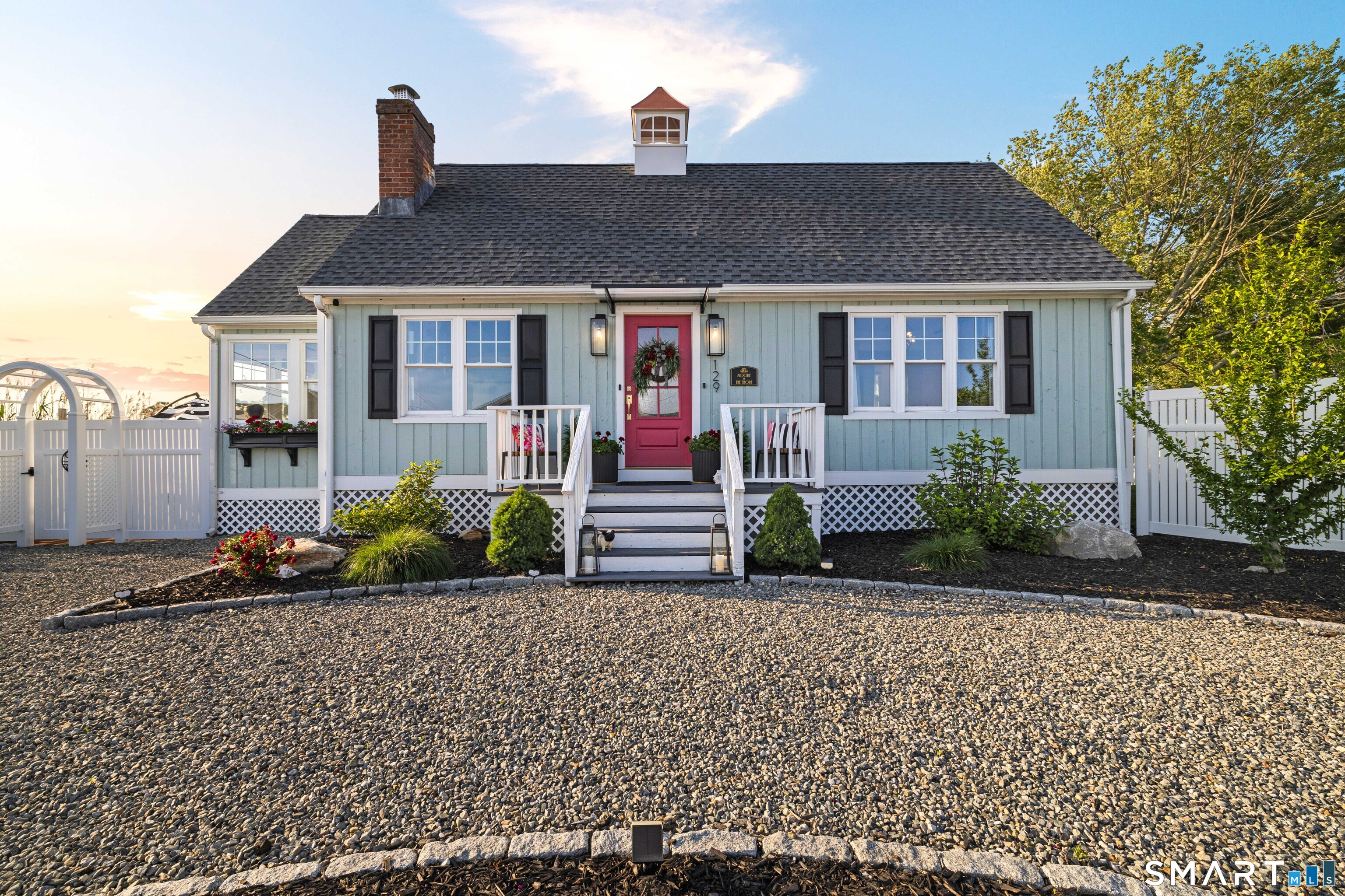129 Nehantic Trail Old Saybrook, CT 06475 - Photo 19 of 28 a front view of a house with a yard