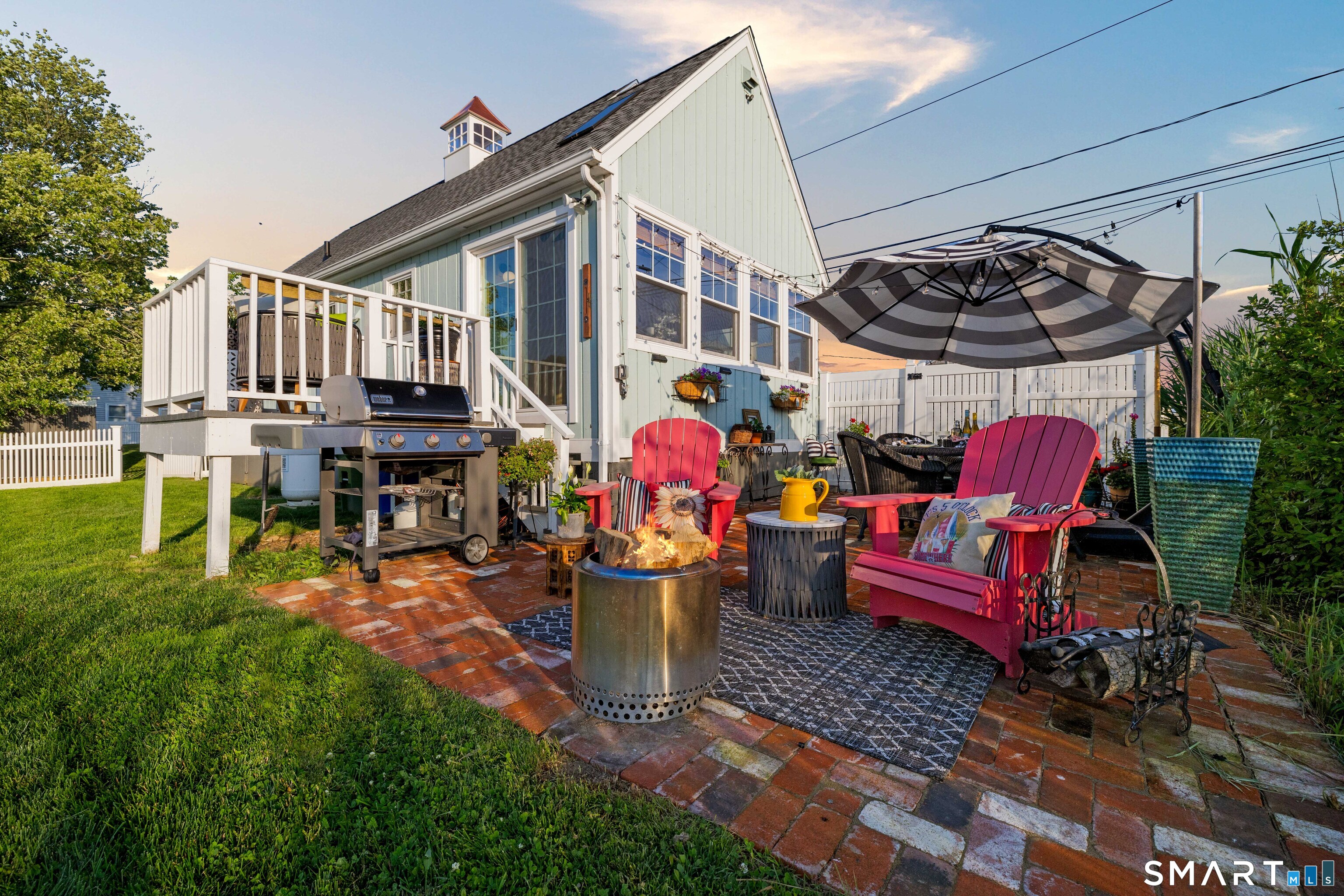 129 Nehantic Trail Old Saybrook, CT 06475 - Photo 20 of 28 a view of a chairs and tables in the back yard of the house