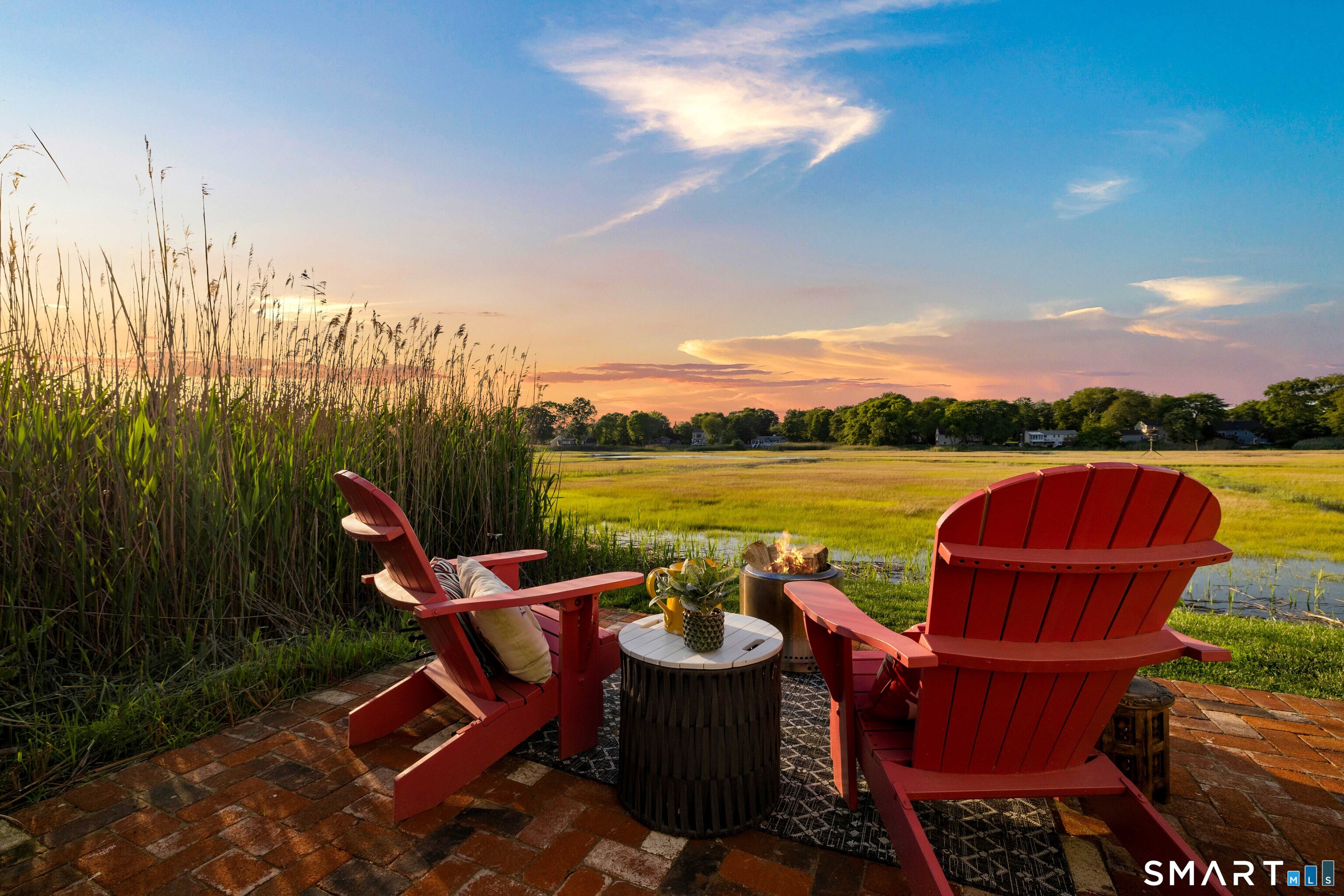129 Nehantic Trail Old Saybrook, CT 06475 - Photo 21 of 28 a patio with water view fountain and outdoor seating