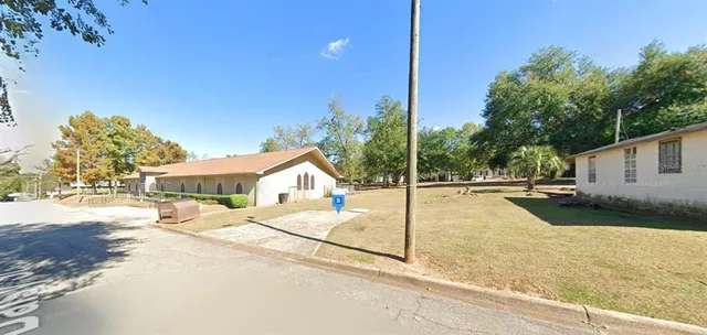 a swimming pool with yard and outdoor seating