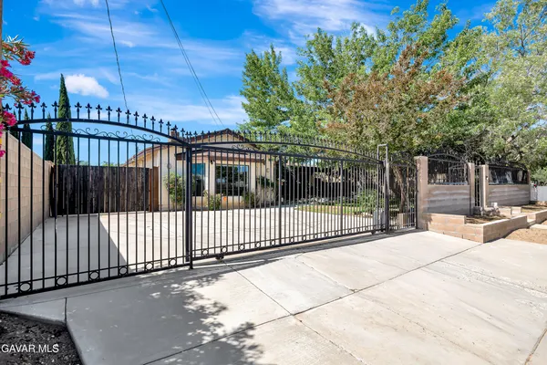 a view of a house with a iron gate