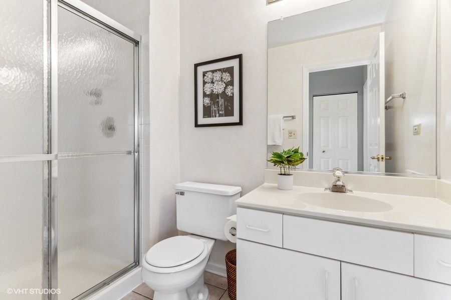 393 Bentley Place Buffalo Grove, IL 60089 - Photo 13 of 16 a bathroom with a sink toilet and a mirror