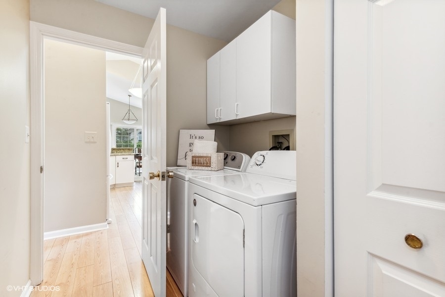 393 Bentley Place Buffalo Grove, IL 60089 - Photo 14 of 16 a view of washer and dryer with kitchen in the background
