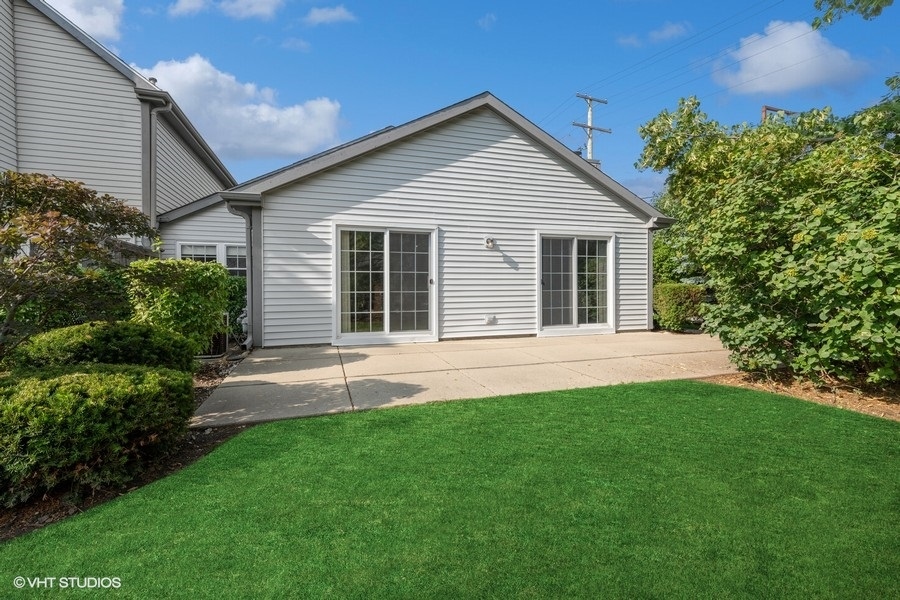 393 Bentley Place Buffalo Grove, IL 60089 - Photo 16 of 16 a view of a house with a yard and potted plants